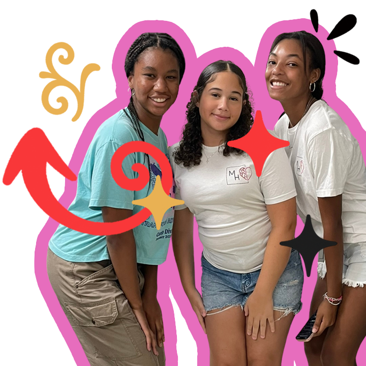 Mila standing with two teenaged volunteers at an MH Boxes event