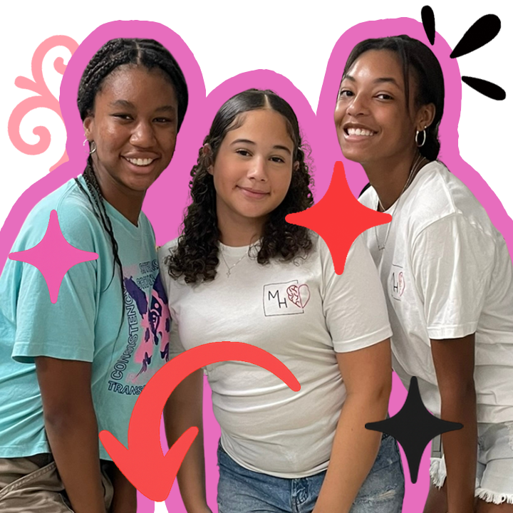 Mila and two teenaged black friends standing together. Mila is in the center wearing an MH Boxes branded t-shirt.
